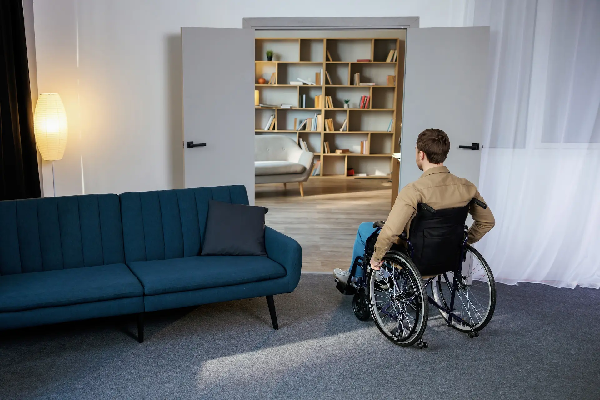 Person in wheelchair in living room with wide doorway