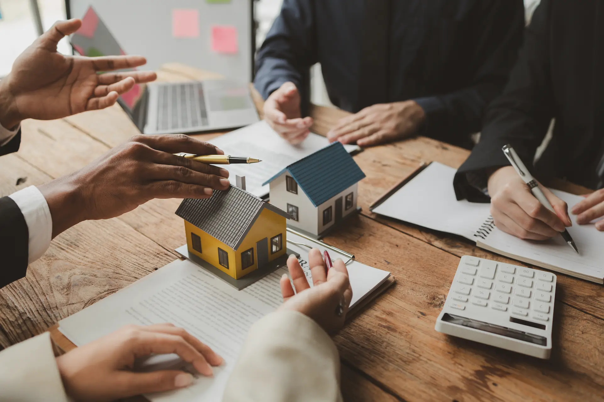 Consultation meeting with house model and contract papers