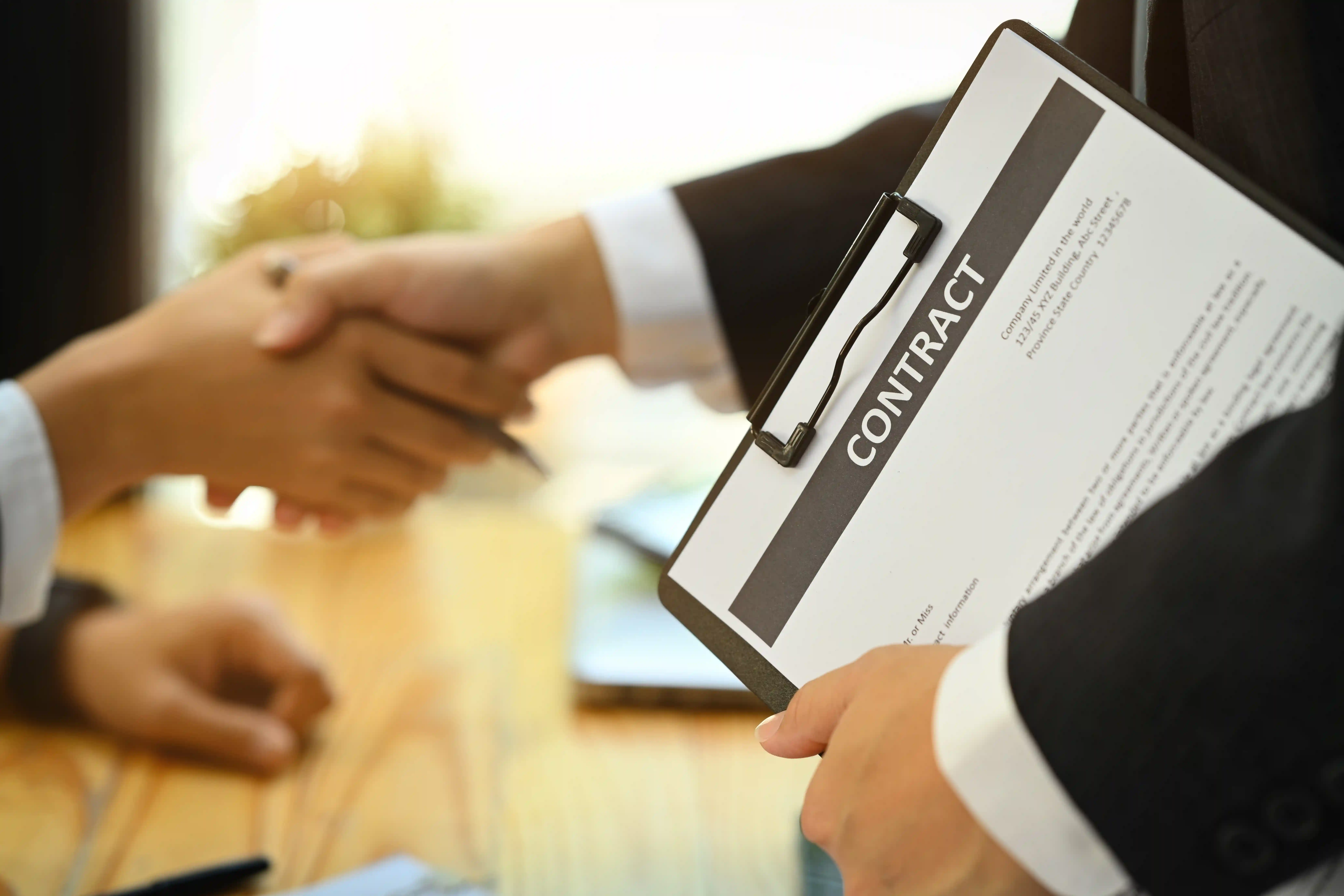 Handshake after signing a contract