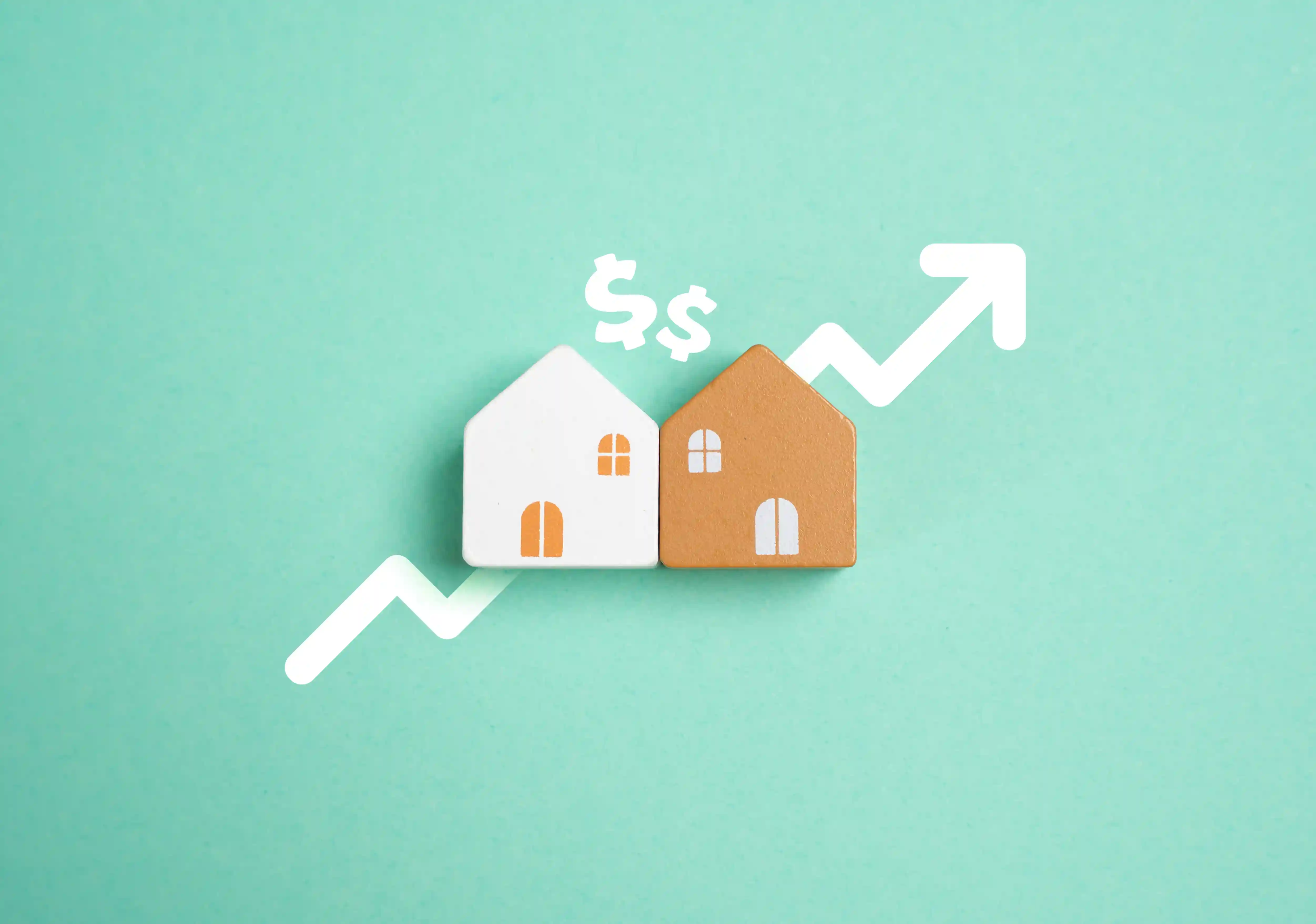 Two small model houses on a green background with an upward curve and dollar signs – symbol for real estate prices.