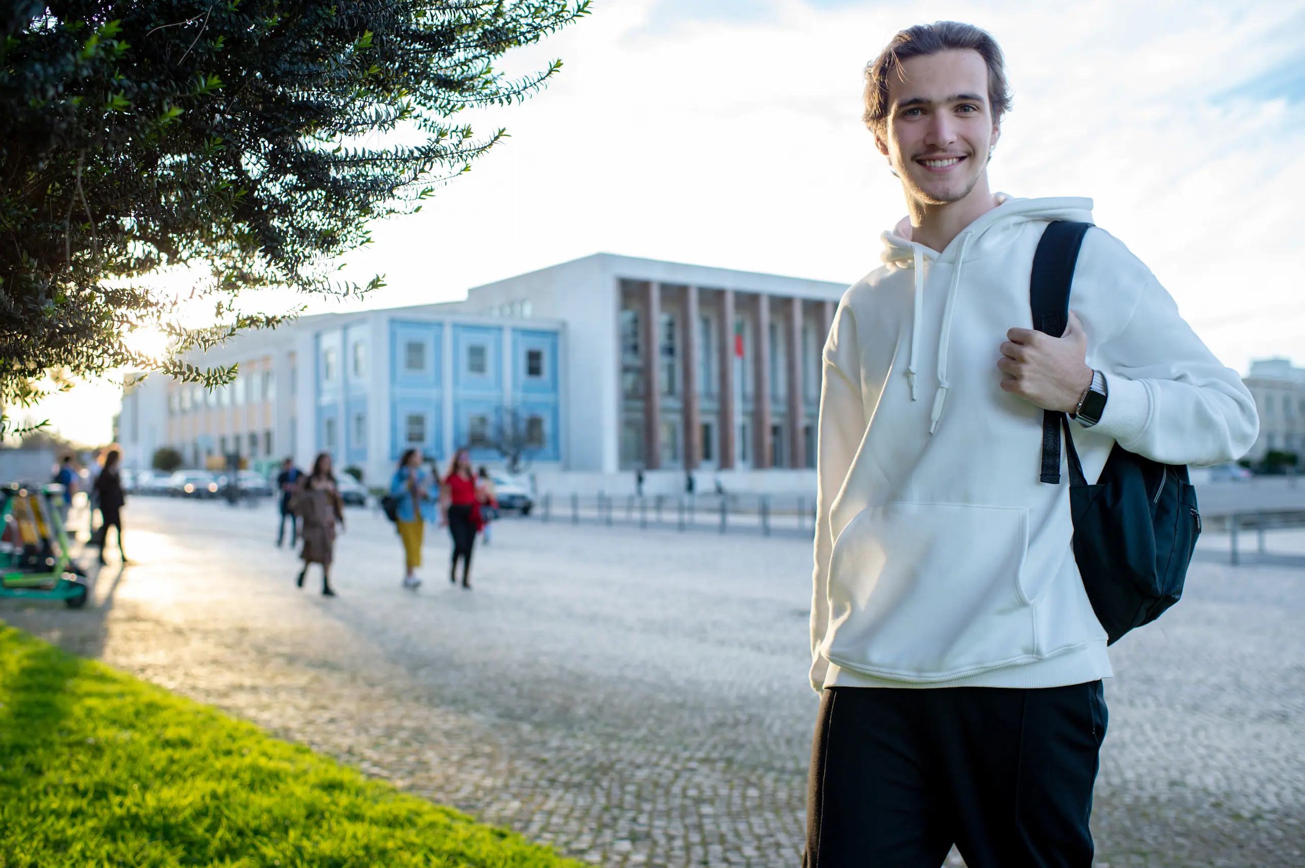 Student in Berlin with backpack in front of university buildings – urban life in the capital.