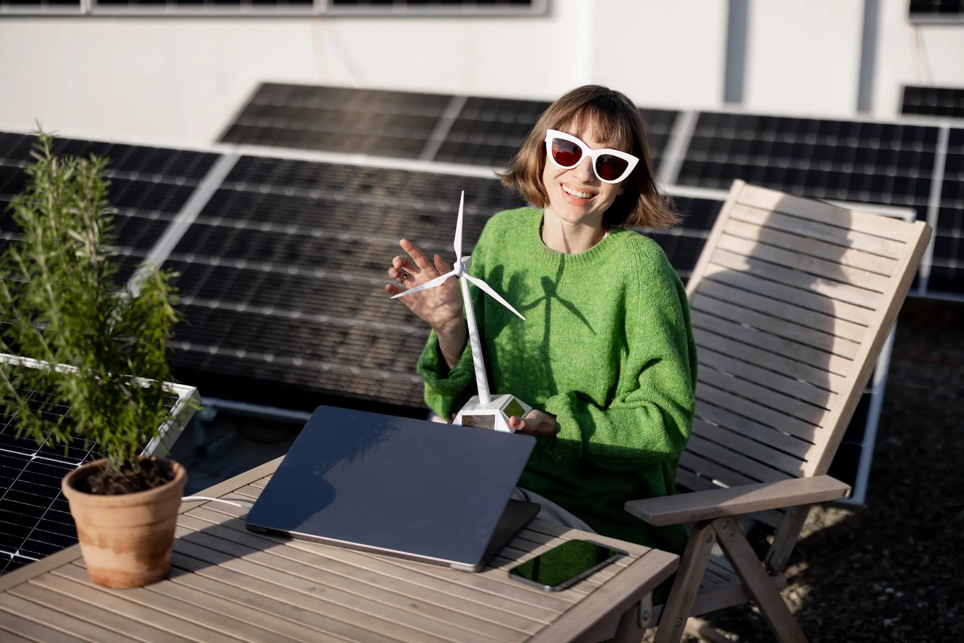 Woman on rooftop terrace with photovoltaic panels – symbol of urban solar power