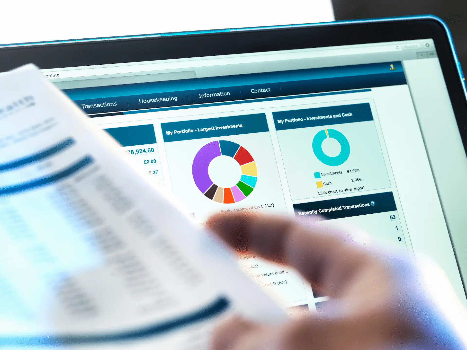 Laptop screen showing portfolio charts and financial overview, focusing on investments and budget planning.