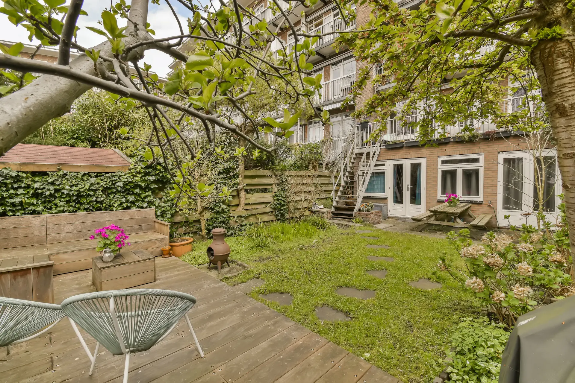 Green backyard behind a residential building in Berlin, ideal for a family apartment Berlin.