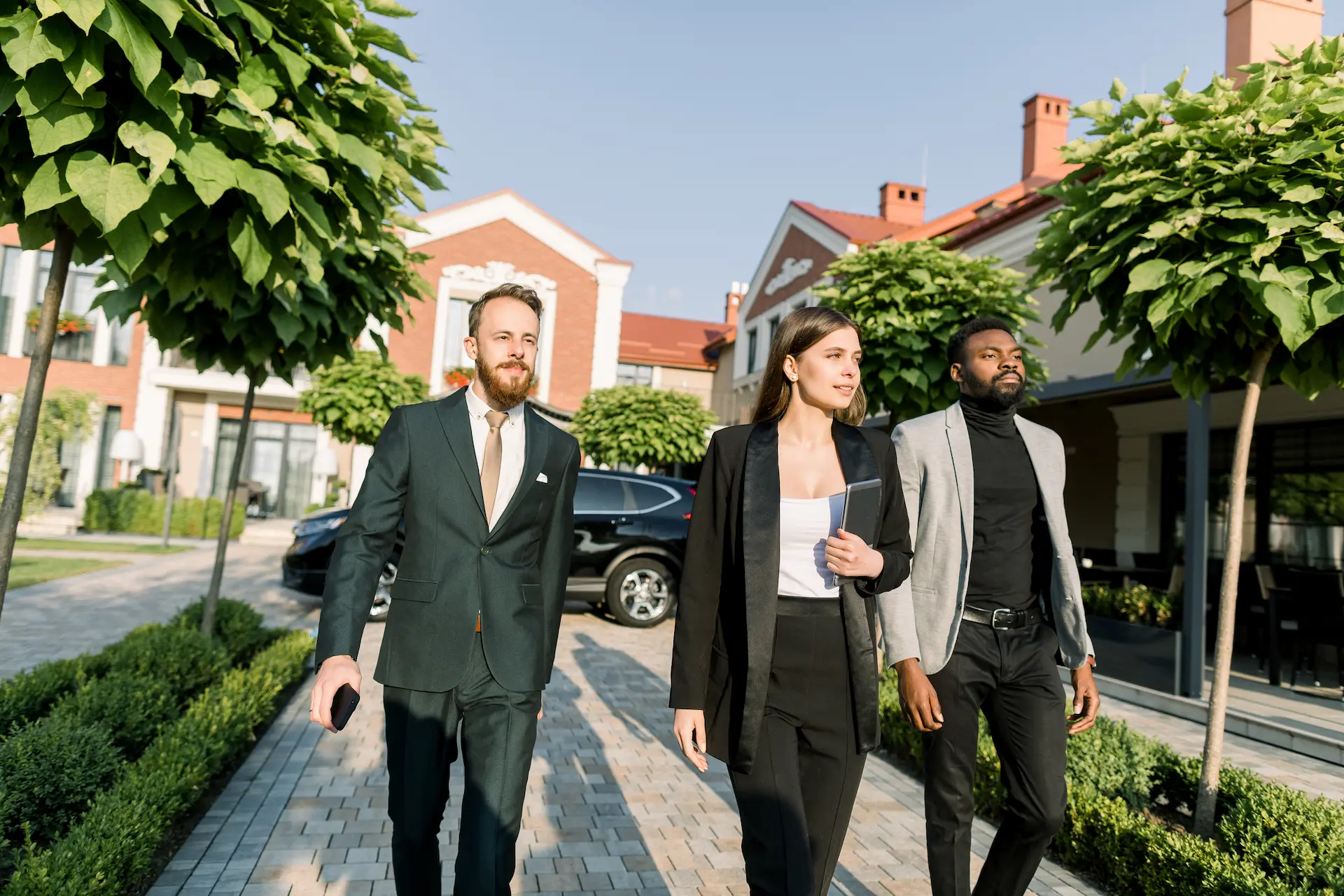 Team of real estate professionals walking through premium residential areas in Berlin, related to real estate investment Berlin.
