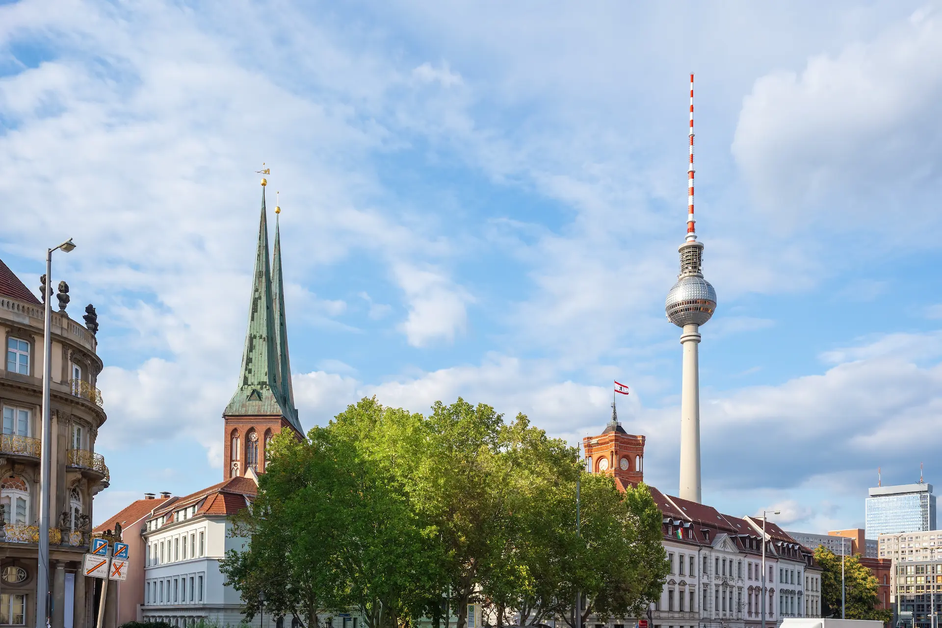 Berlin TV Tower and church above the city rooftops.