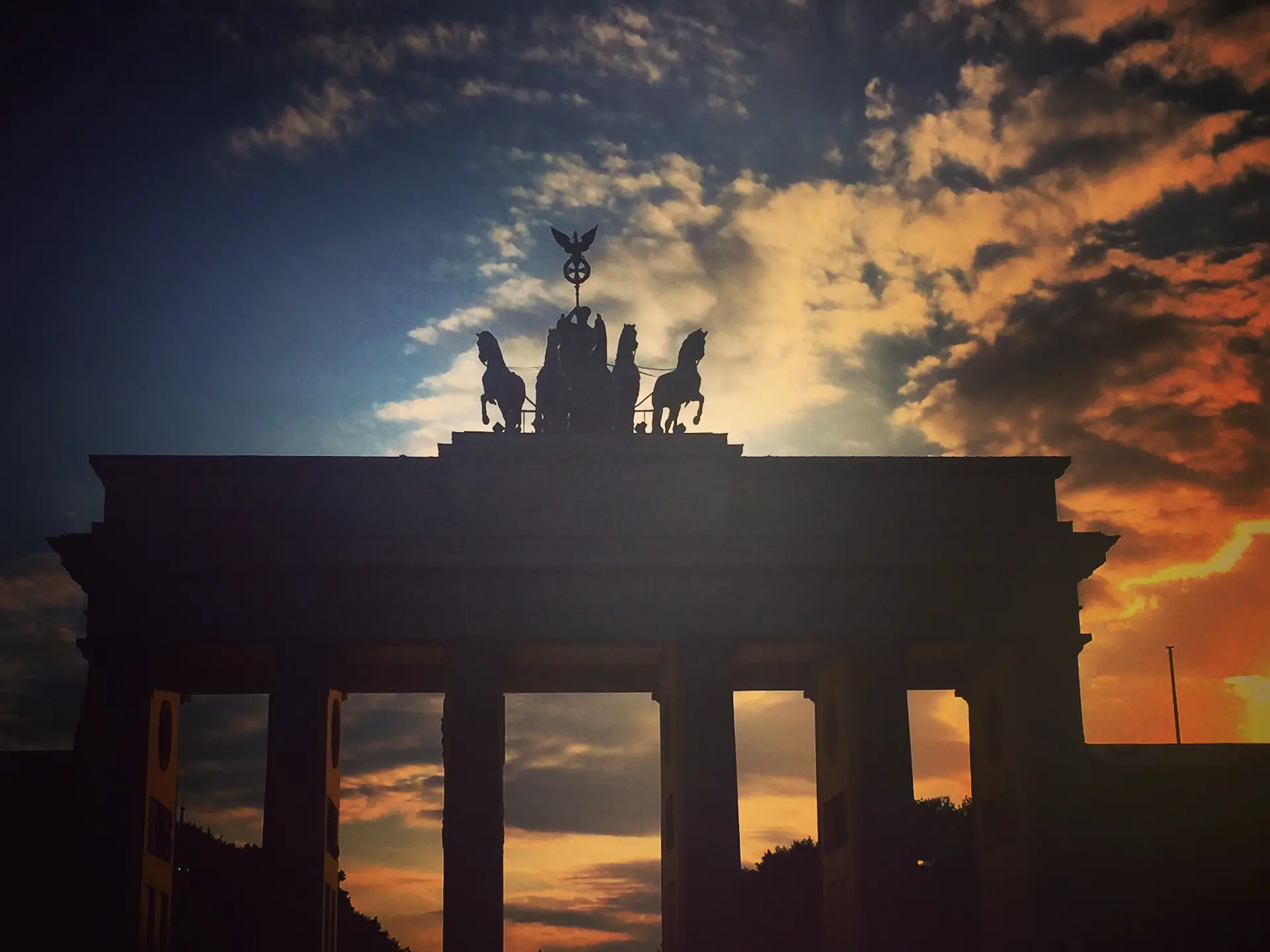 Brandenburg Gate silhouetted at sunset