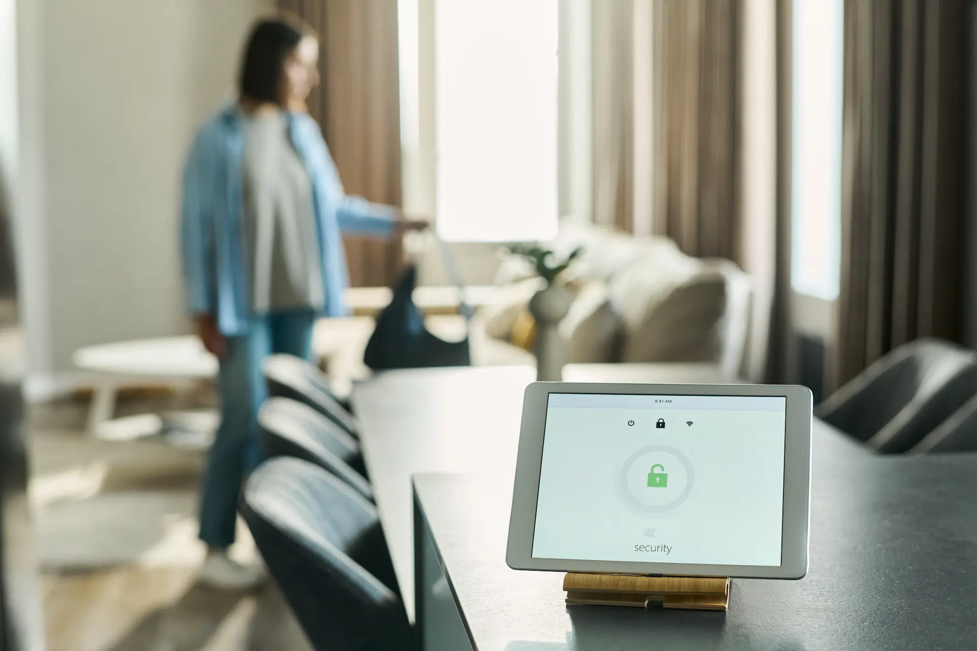 Smart home security display on tablet in modern living room