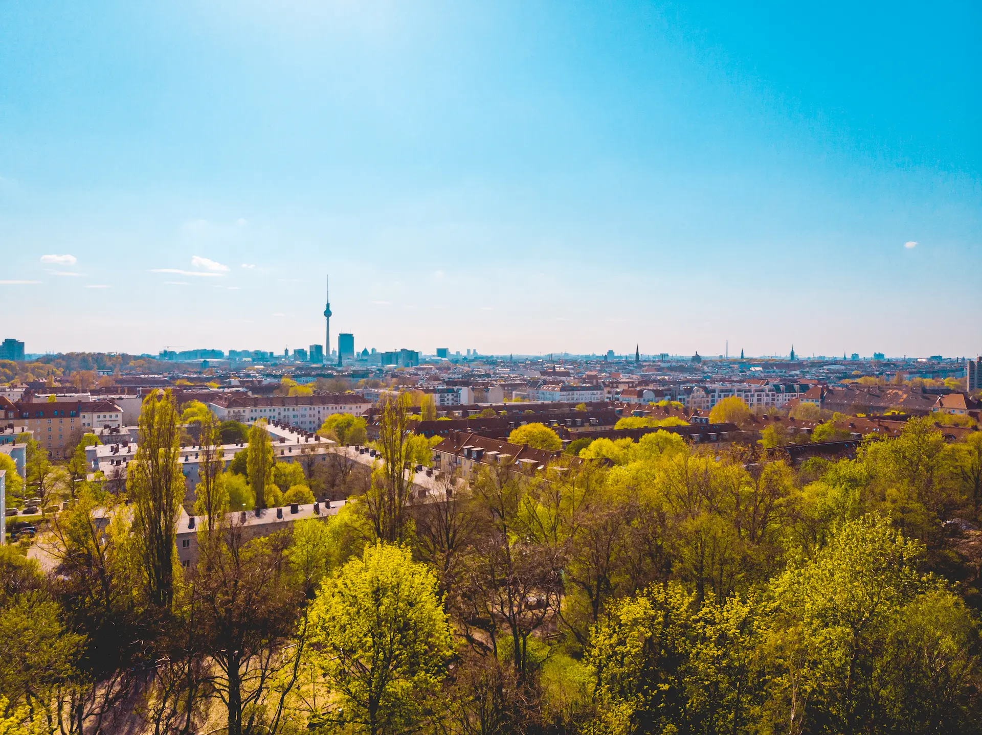 Spring city skyline with green trees and TV tower on the horizon