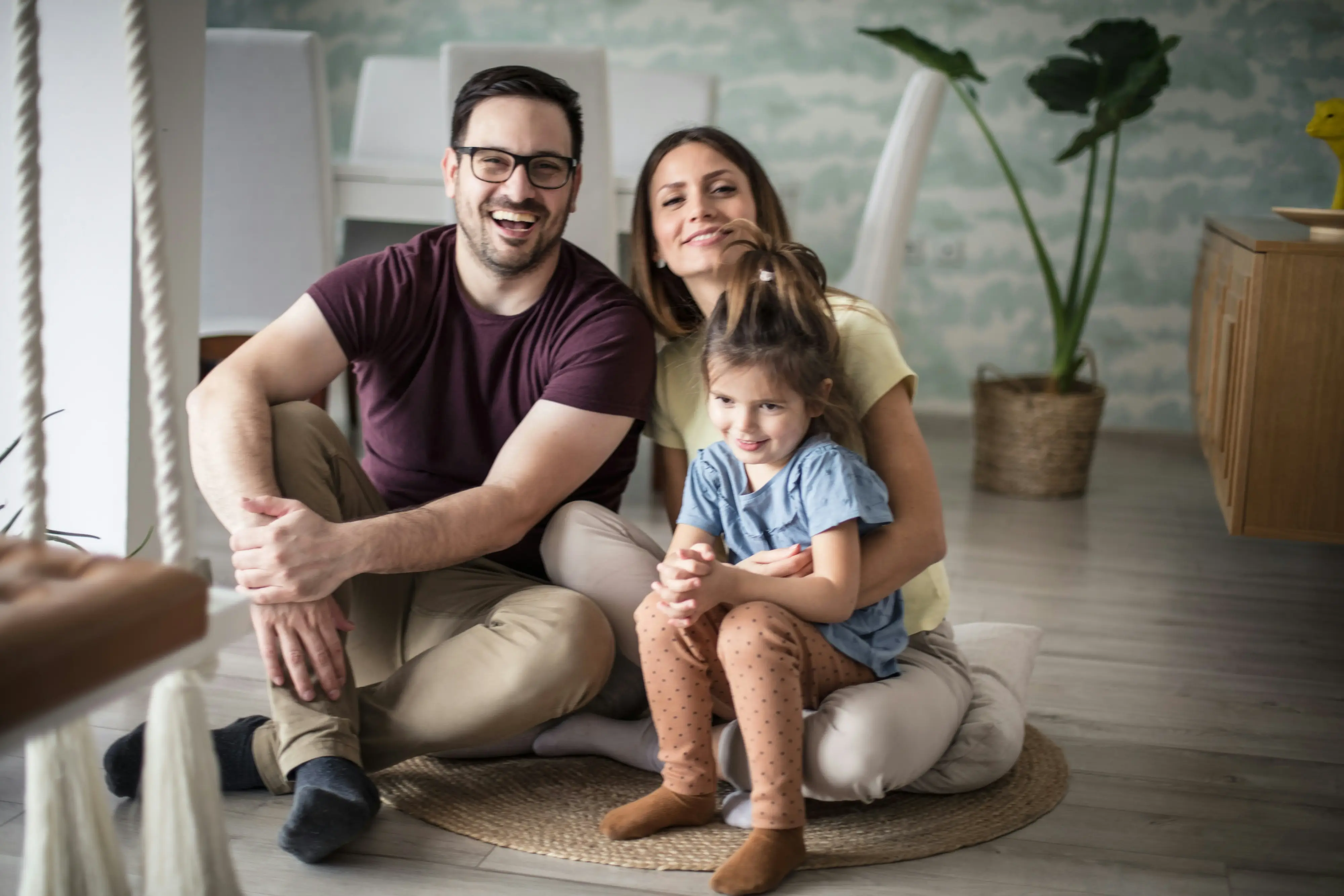 Happy family sitting together in the living room.