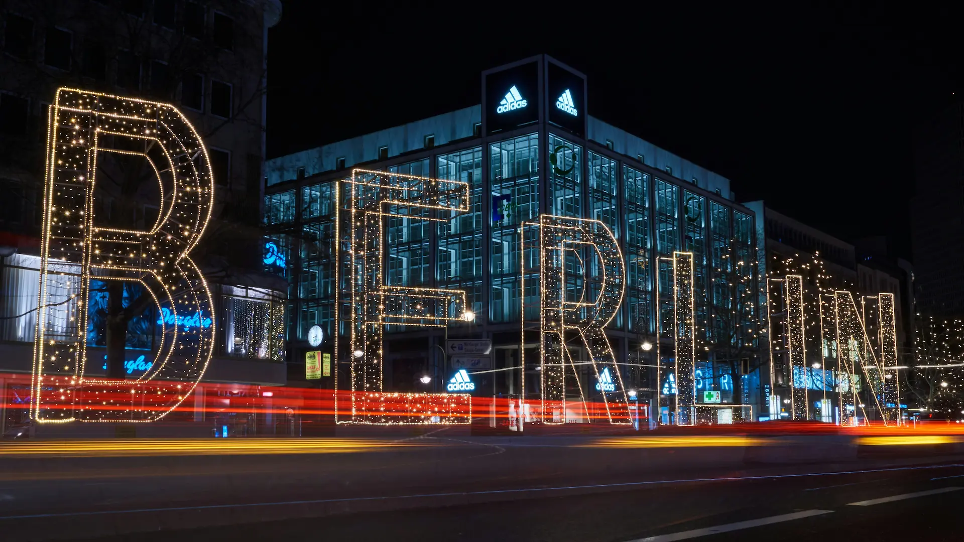 Berlin at night with illuminated lettering and modern architecture