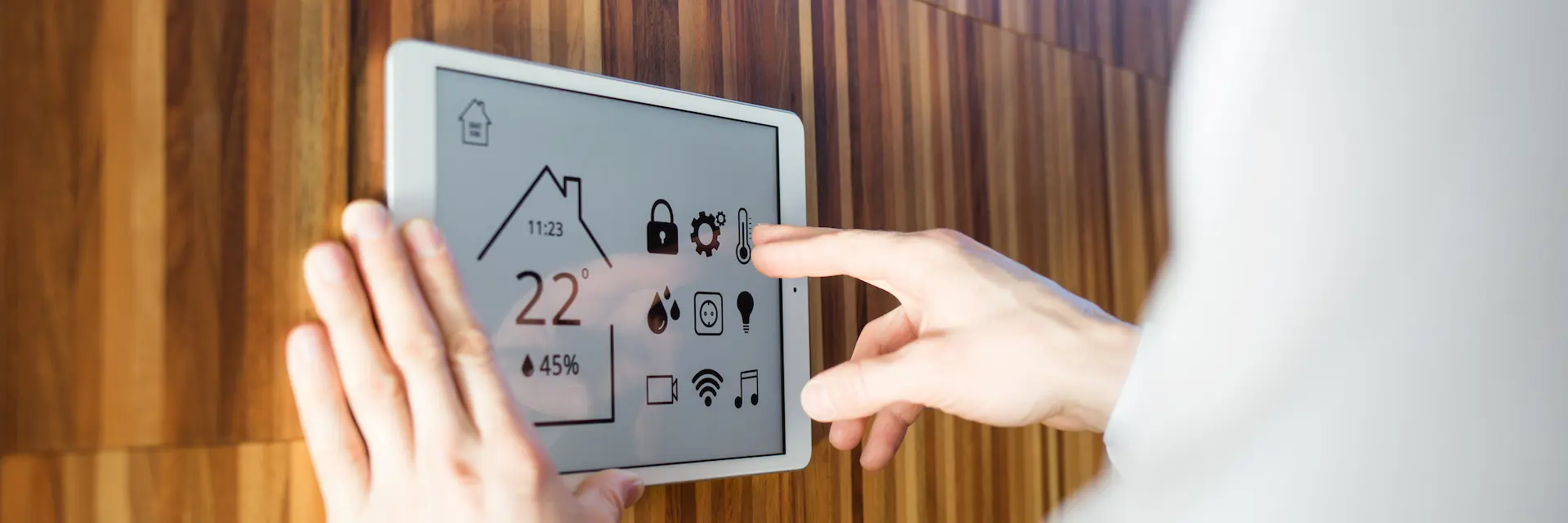 Person using wall mounted smart home display