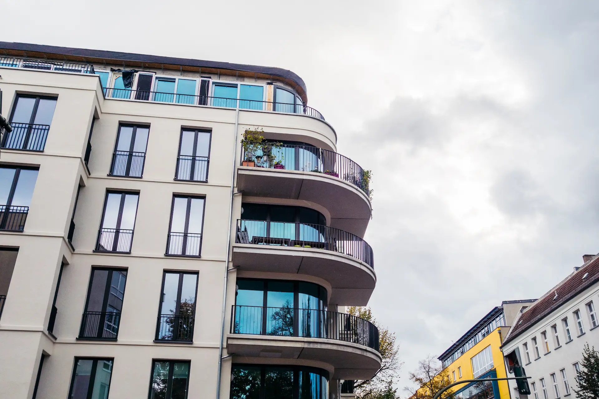 Modern apartment building with balconies in an urban area.