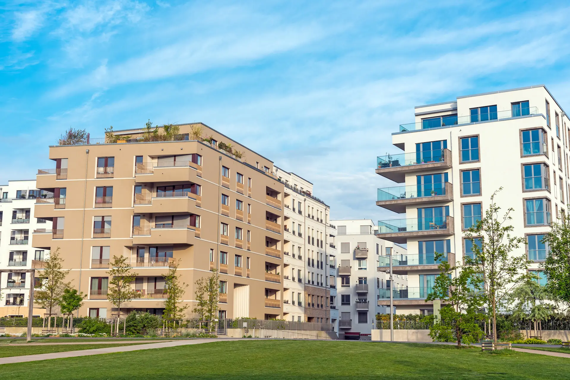 Modern apartment buildings with balconies and green spaces