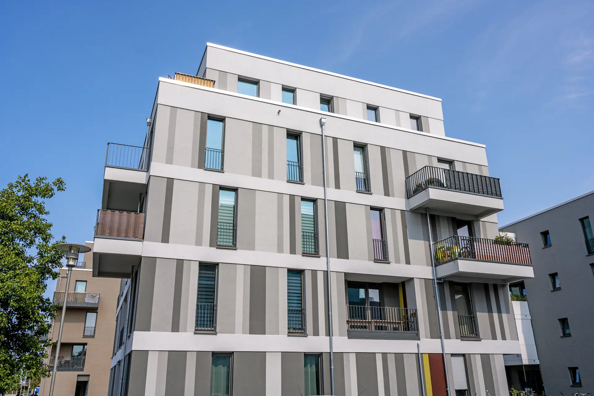 Contemporary residential building with clean facade and balconies.