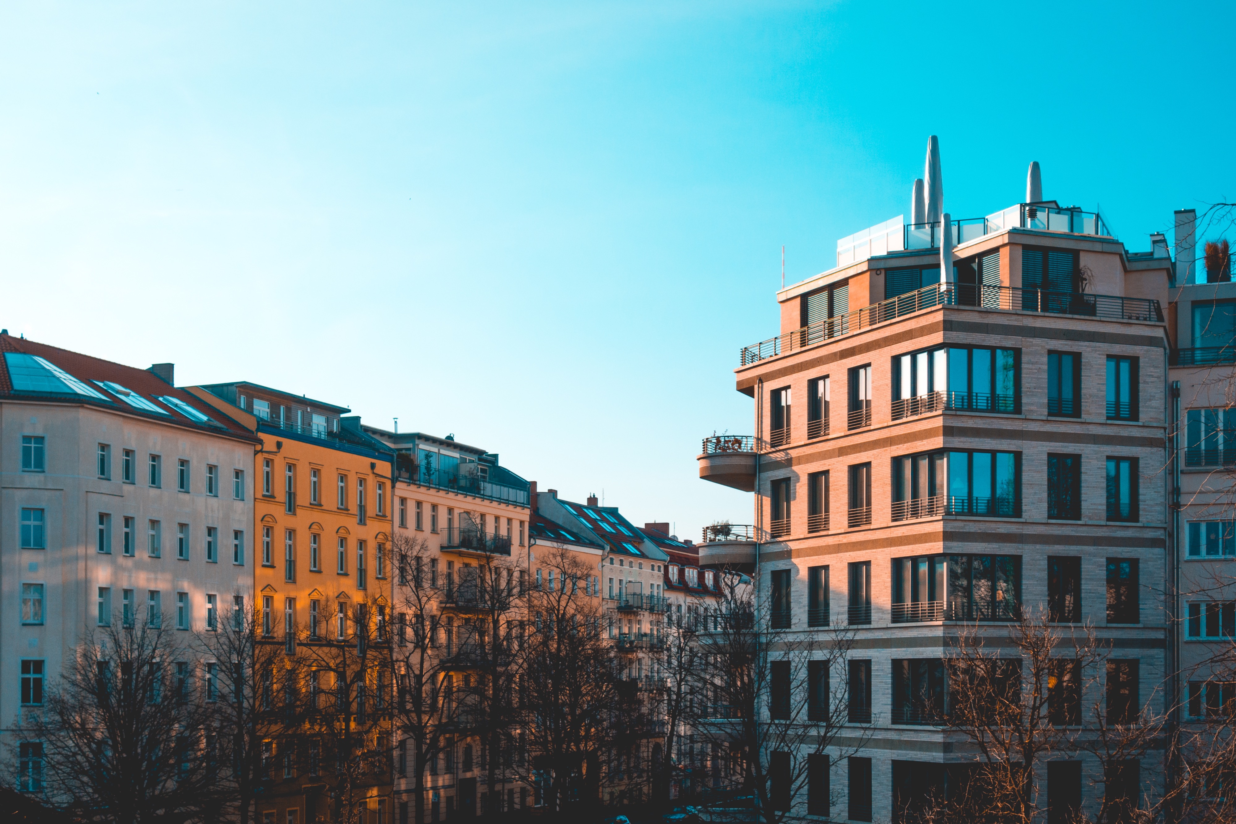 City facades in evening light with modern corner building