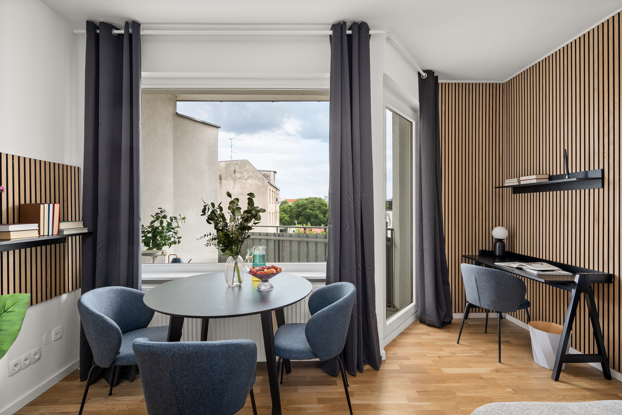 Modern Berlin apartment with dining area and home office space – showcasing contemporary living and real estate standards in Berlin 2025.