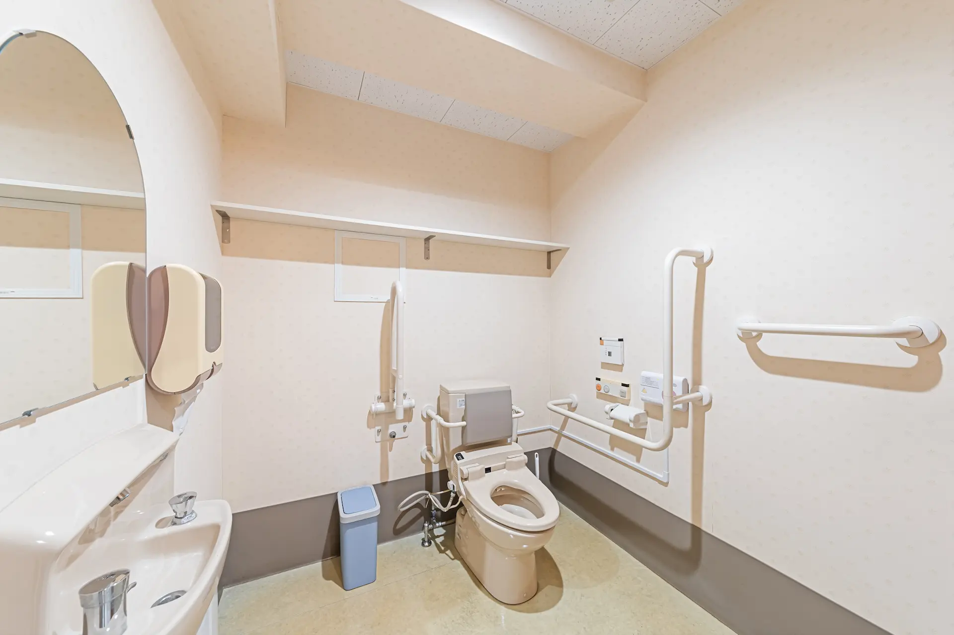 Accessible bathroom with grab bars and adapted toilet