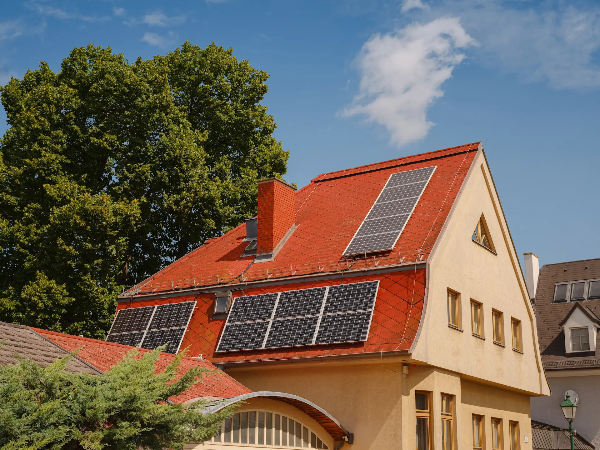 Single-family house with solar panels on a red tiled roof