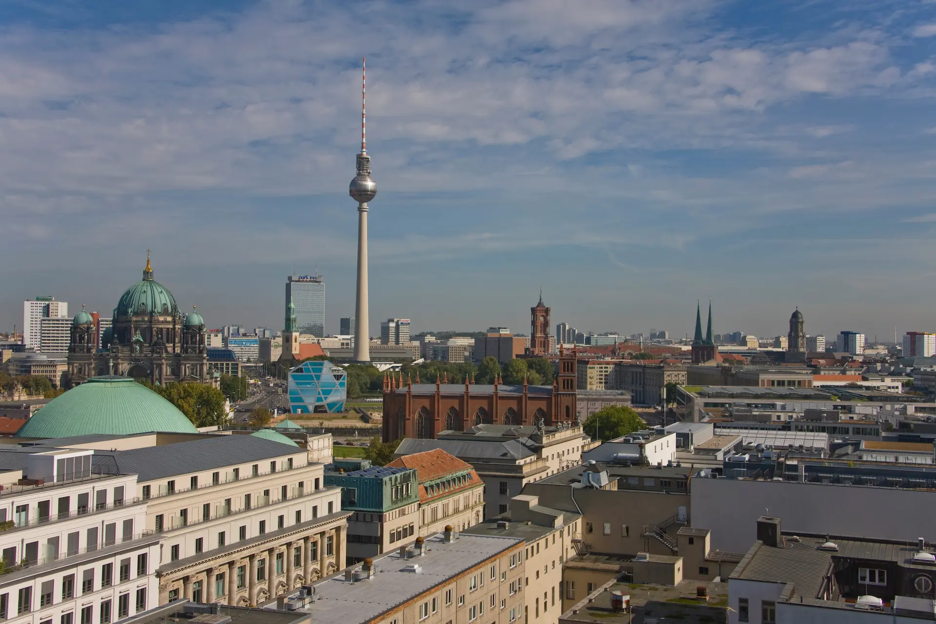 Berlin skyline with the TV Tower and Berlin Cathedral under a clear sky.