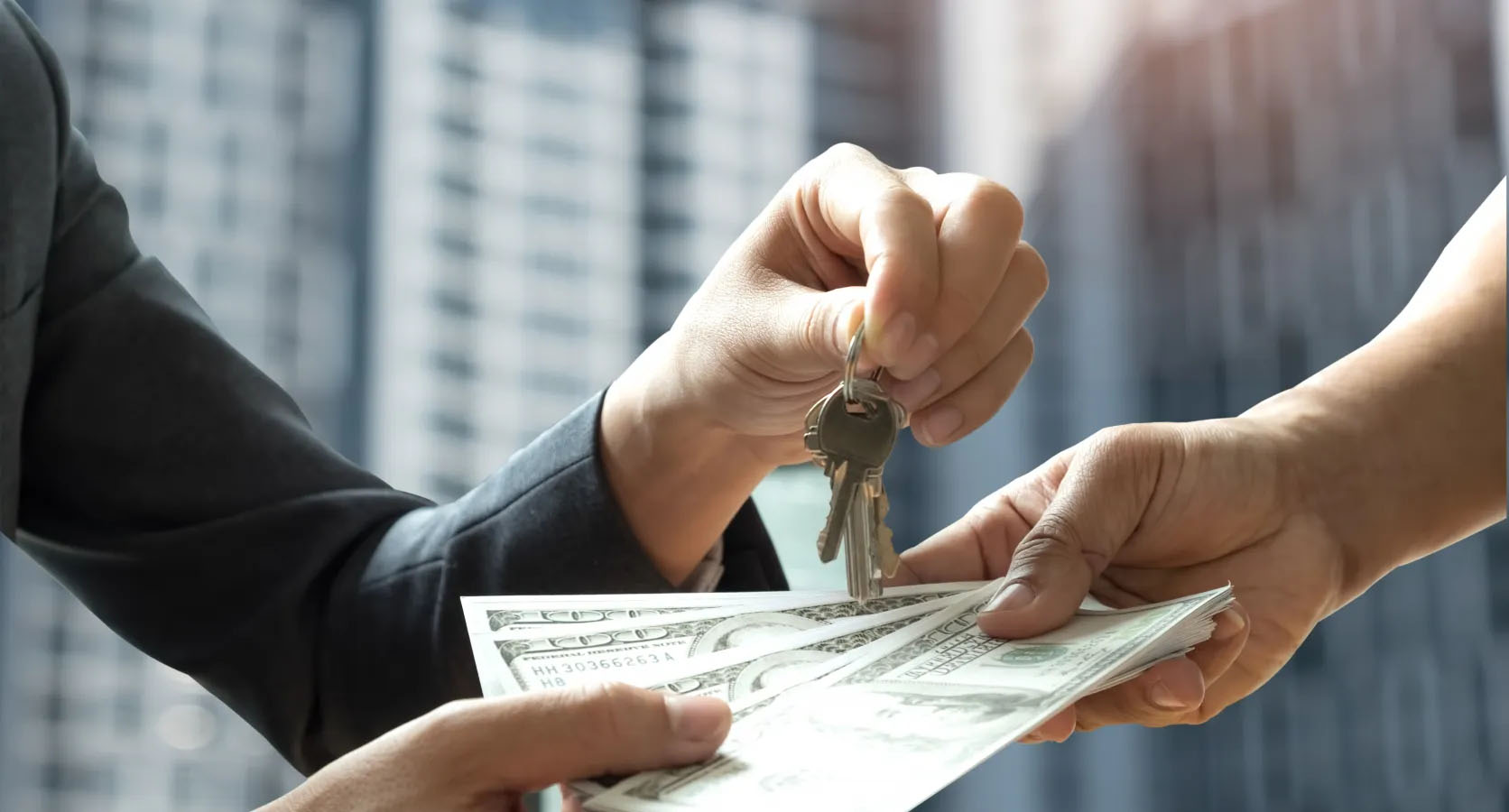 Nahaufnahme einer Schlüsselübergabe gegen Bargeld vor einem modernen Hochhaus, Symbol für Wohnungskauf oder Immobilienfinanzierung.