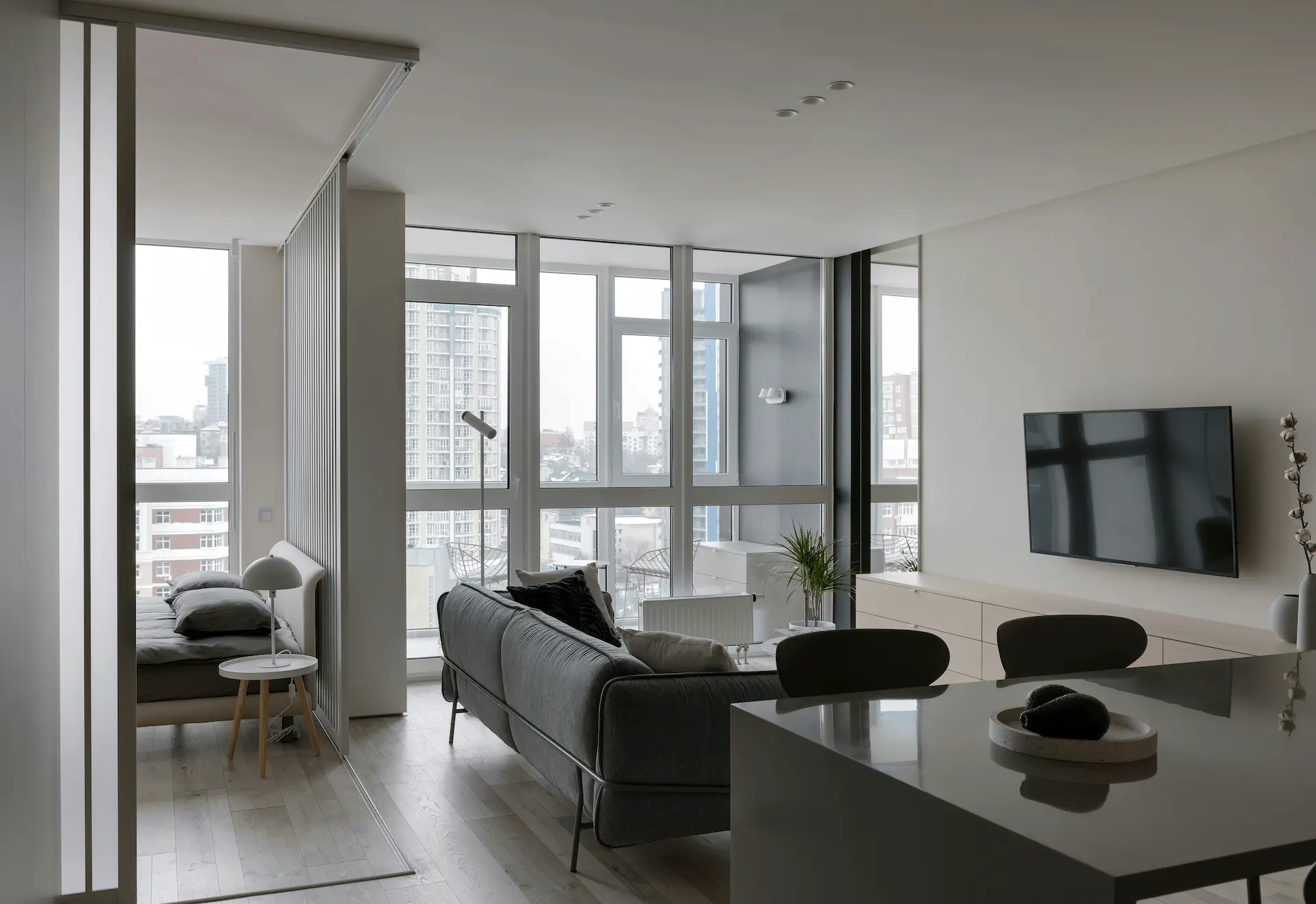 Modern bright living room with large windows and city view